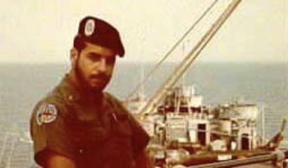 A person in uniform standing on a boatAI-generated content may be incorrect.